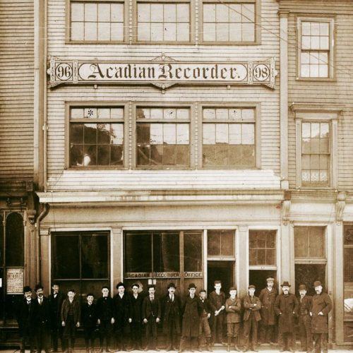 Group of workers standing in front of the Acadian Recorder in downtown Halifax